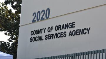 Photo of the building address at 2020 W. Walnut St. in Santa Ana. Features a sign saying "County of Orange Social Services Agency"