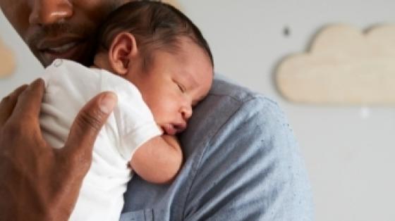 A man holds a baby