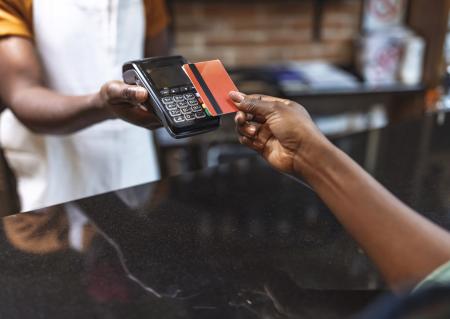 Hand holding EBT card to scan in card reader